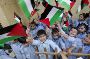 176108-palestinian-children-wave-their-national-flags-at-the-burj-al-barajneh-770x513
