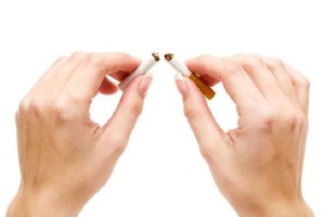 Woman breaking a cigarette. Isolated on a white background.