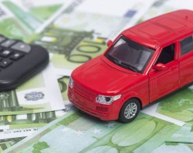 red car and money, euro and dollars. insurance concept