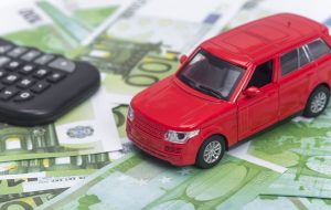 red car and money, euro and dollars. insurance concept